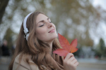 Photo by Andrea Piacquadio: https://www.pexels.com/photo/young-satisfied-woman-in-headphones-with-fresh-red-leaf-listening-to-music-with-pleasure-while-lounging-in-autumn-park-3776557/